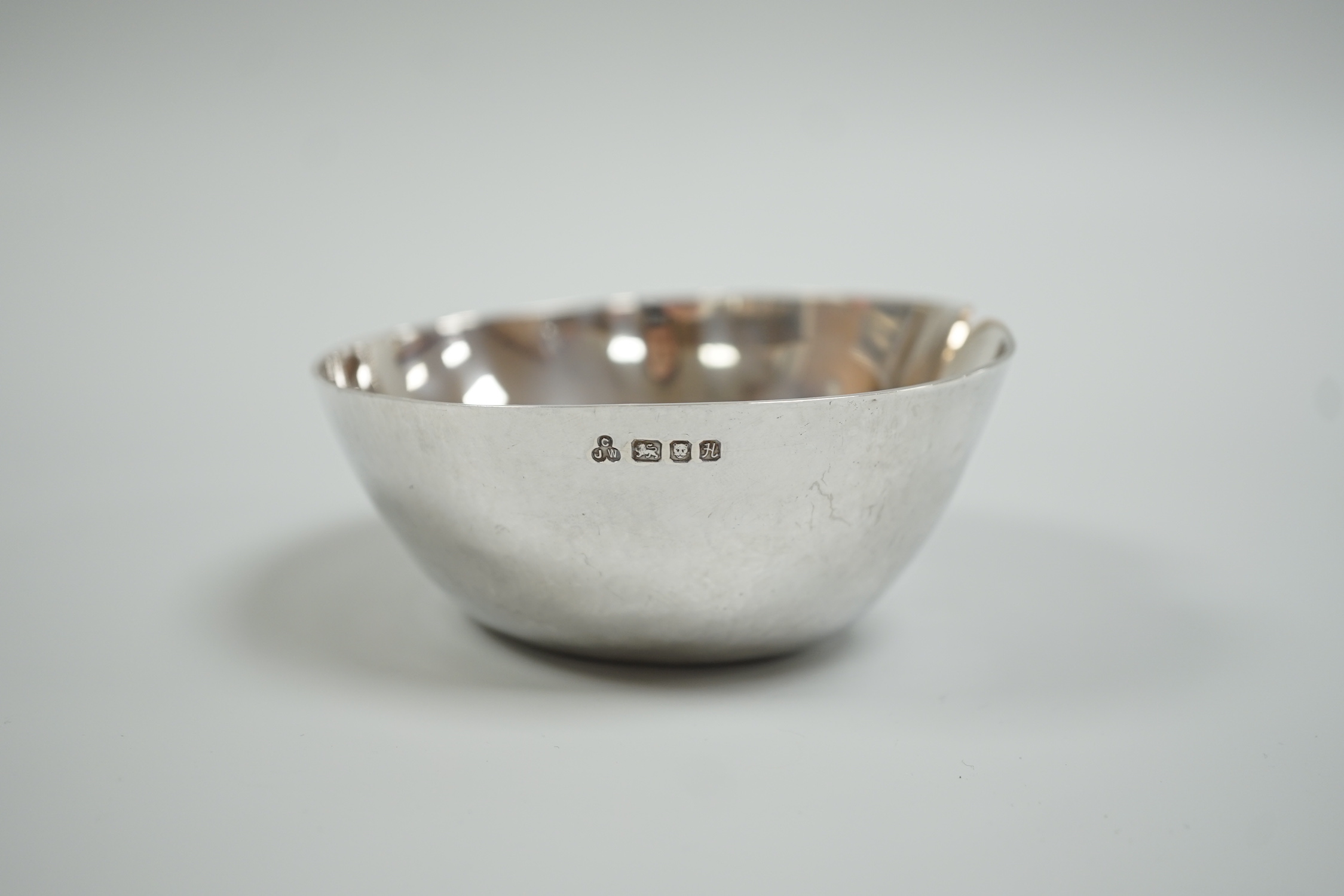 A modern silver dimpled bowl, maker CJW, London, 1982, width 10cm, 116 grams.